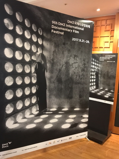 아프가니스탄 카불의 한 초등학교 쉬는 시간, 빛이 들어오는 작은 구멍으로 운동장에서 뛰어노는 친구들을 바라보고 있는 소녀의 모습을 포착한 사진을 통해 DMZ국제다큐영화제는 다큐멘터리의 진정성과 그 정신의 가치를 표현하고자 했다.