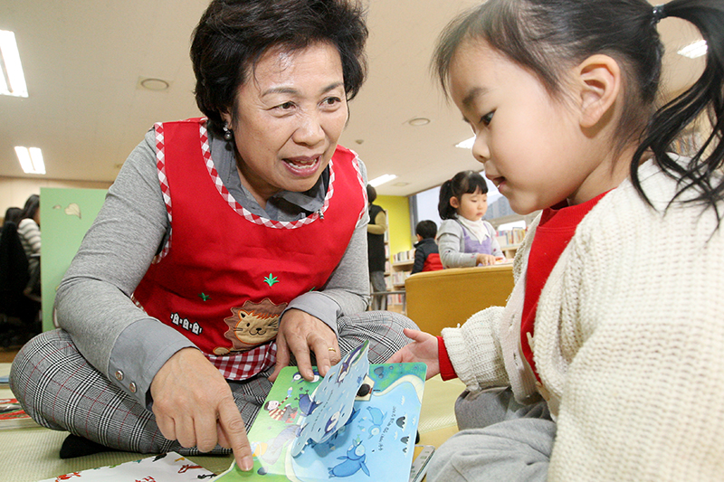 박정란 국장이 수원 서호가족도서관에서 아이들에게 동화책을 읽어주고 있다.