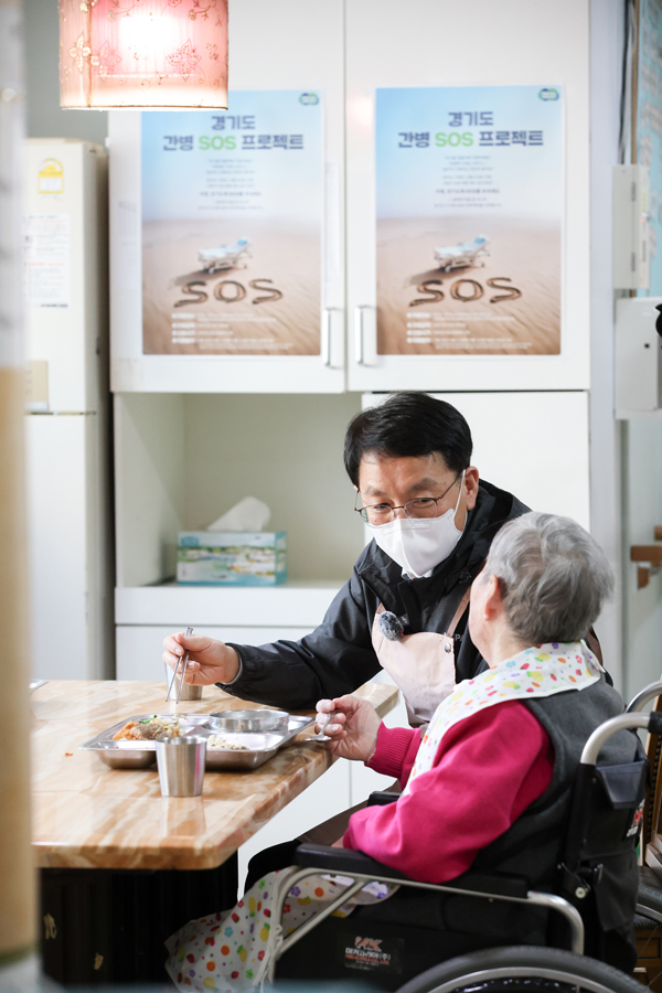 김성중 경기도 행정1부지사가 19일 화성노인전문요양원에서 어르신의 식사를 도우며 대화하고 있습니다.